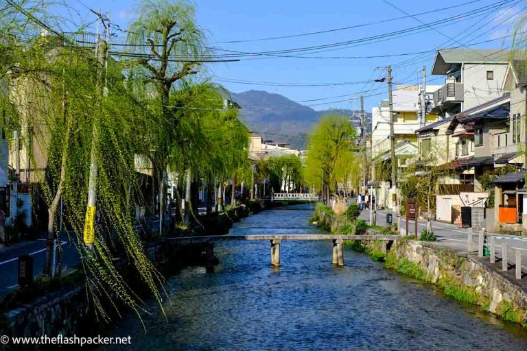 canal in gion in kyoto with 2 small stone bridges