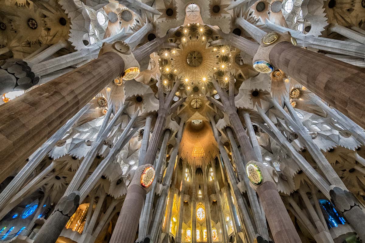 ornate pillars rising up to roof of church seen when visiting la sagrada familia in barcelona