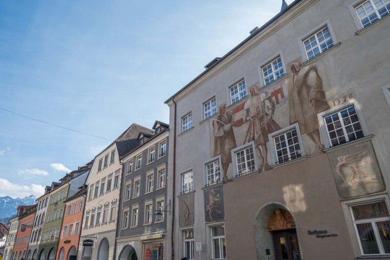 medieval murals of 3 men above the doorway of the rathaus in feldkirch