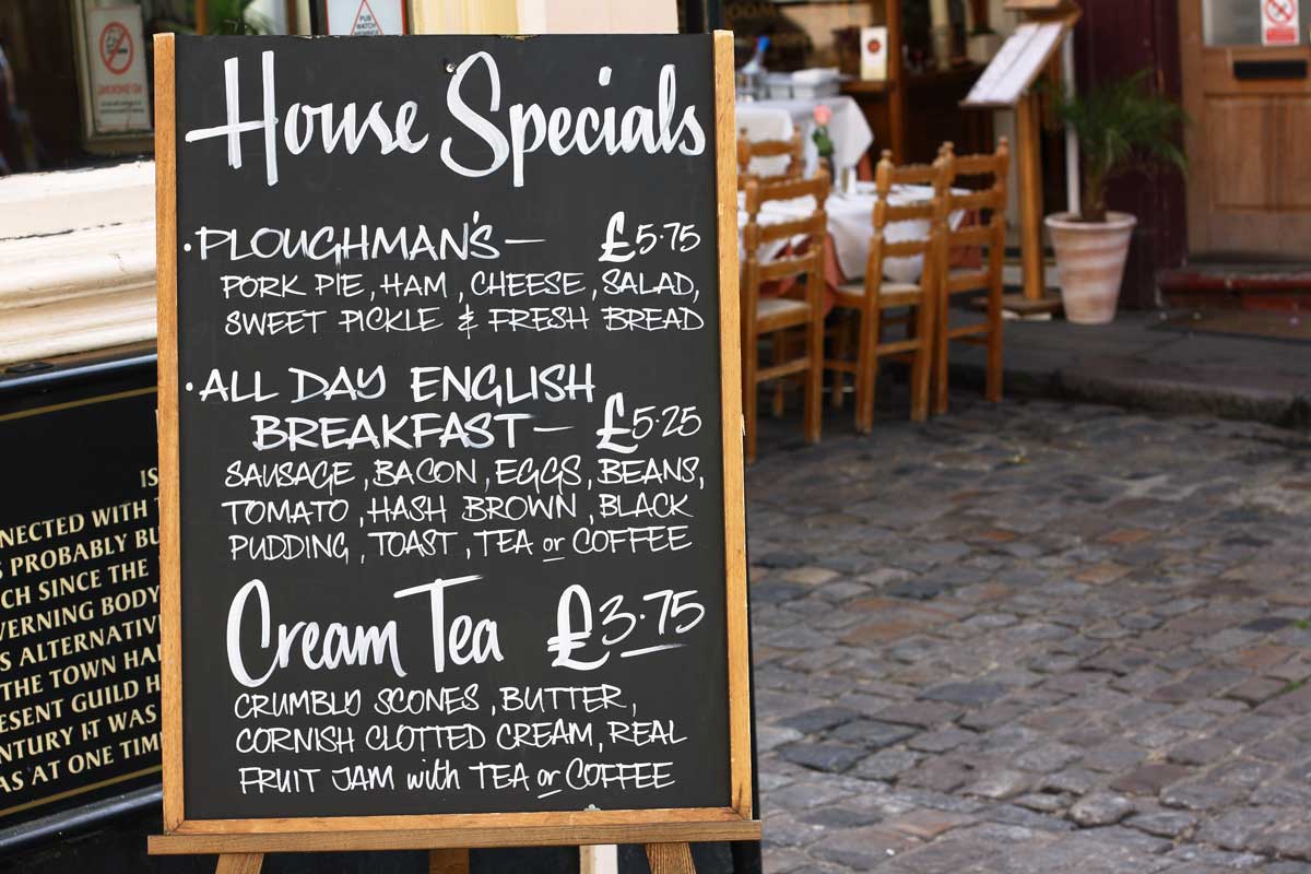 menu board showing london foods outside restaurant