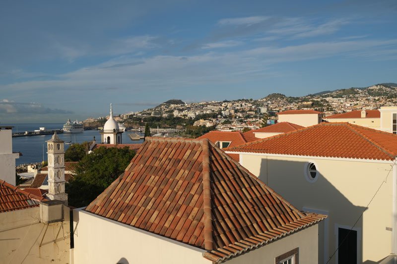 view over red rooftops to the marina of funchal during one week in madeira