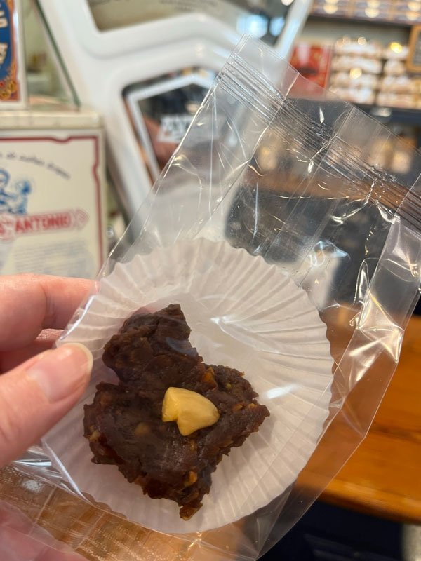 person holding a sample of madeira honey cake