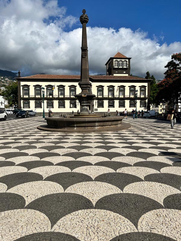 larke square laid with mosaic black and white tiles with a fountain in centre and large two storey building