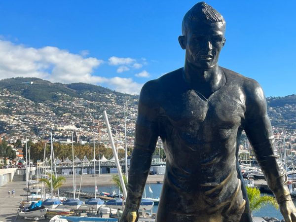 bronze sculpture of cristiano ronaldo in front of funchal marina