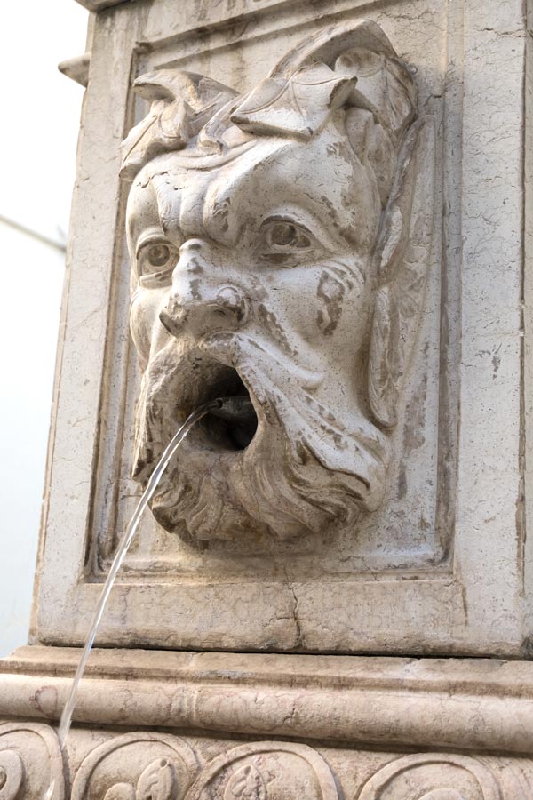 fountain in the shape of a face of mythical being 