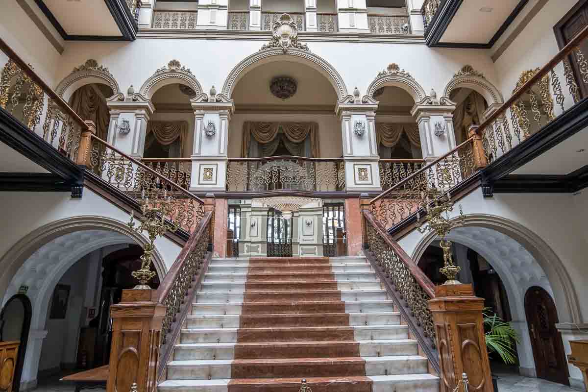 magnificent interior of gabinete librario with sweeping staircase with wooden railings