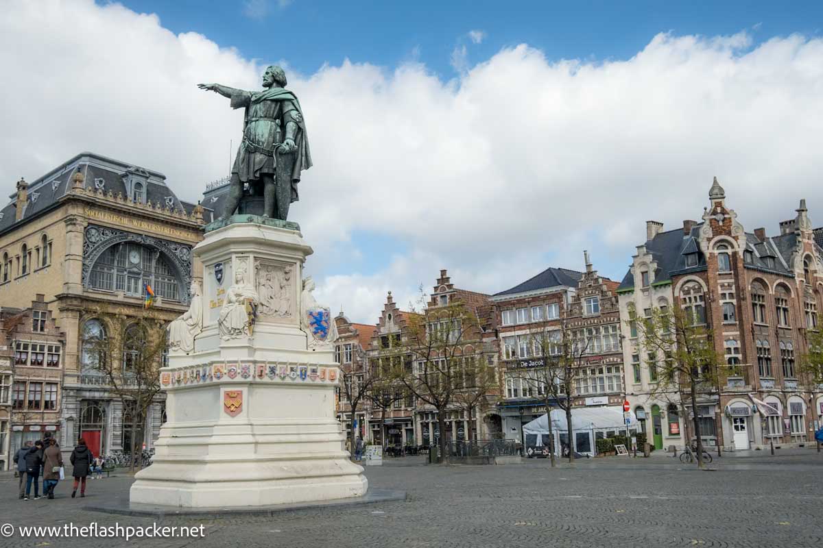 statues of king pointing in a grand square in ghent