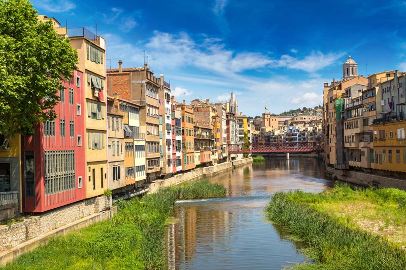 colourful houses along river in girona spain