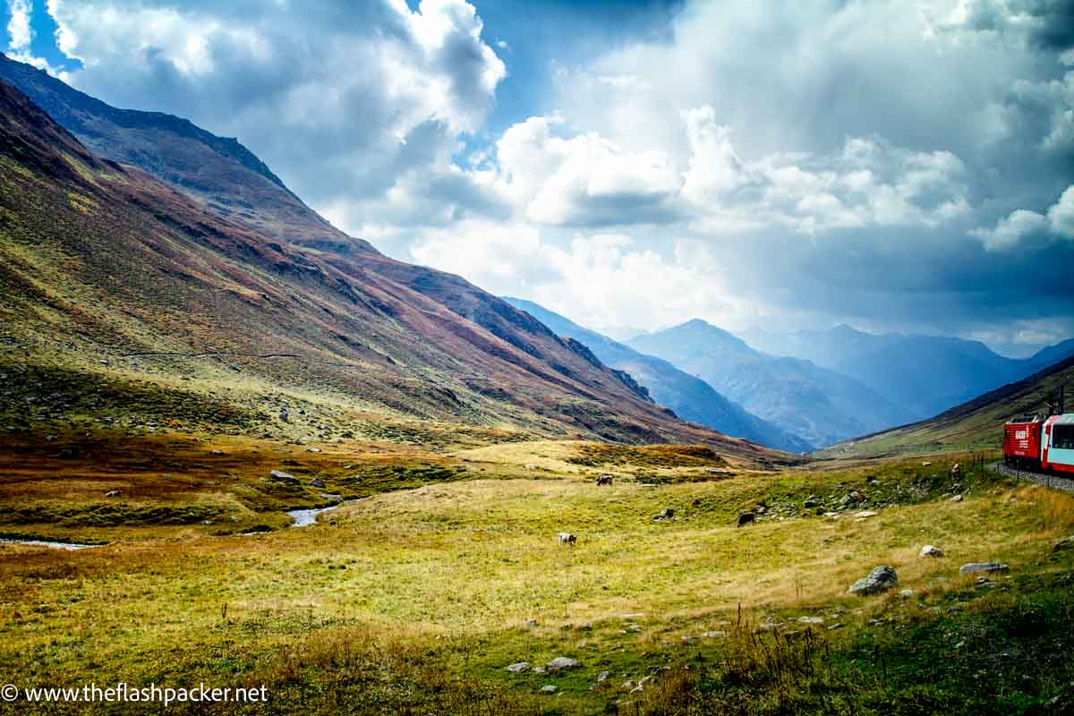 red and white train in swiss valley