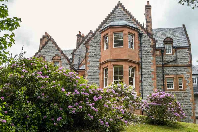 old country manor and garden with purple flowers