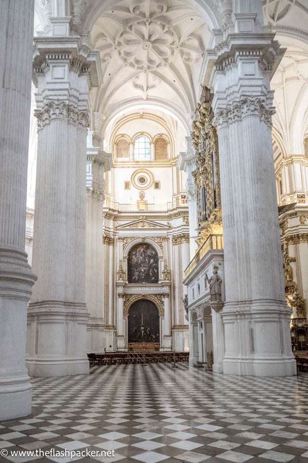 graceful white columns and chequered patterned floor of granada cathedral