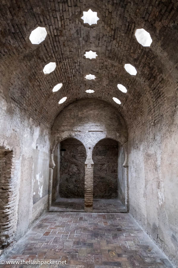 old stone arab baths with two arches and star shaped skylights