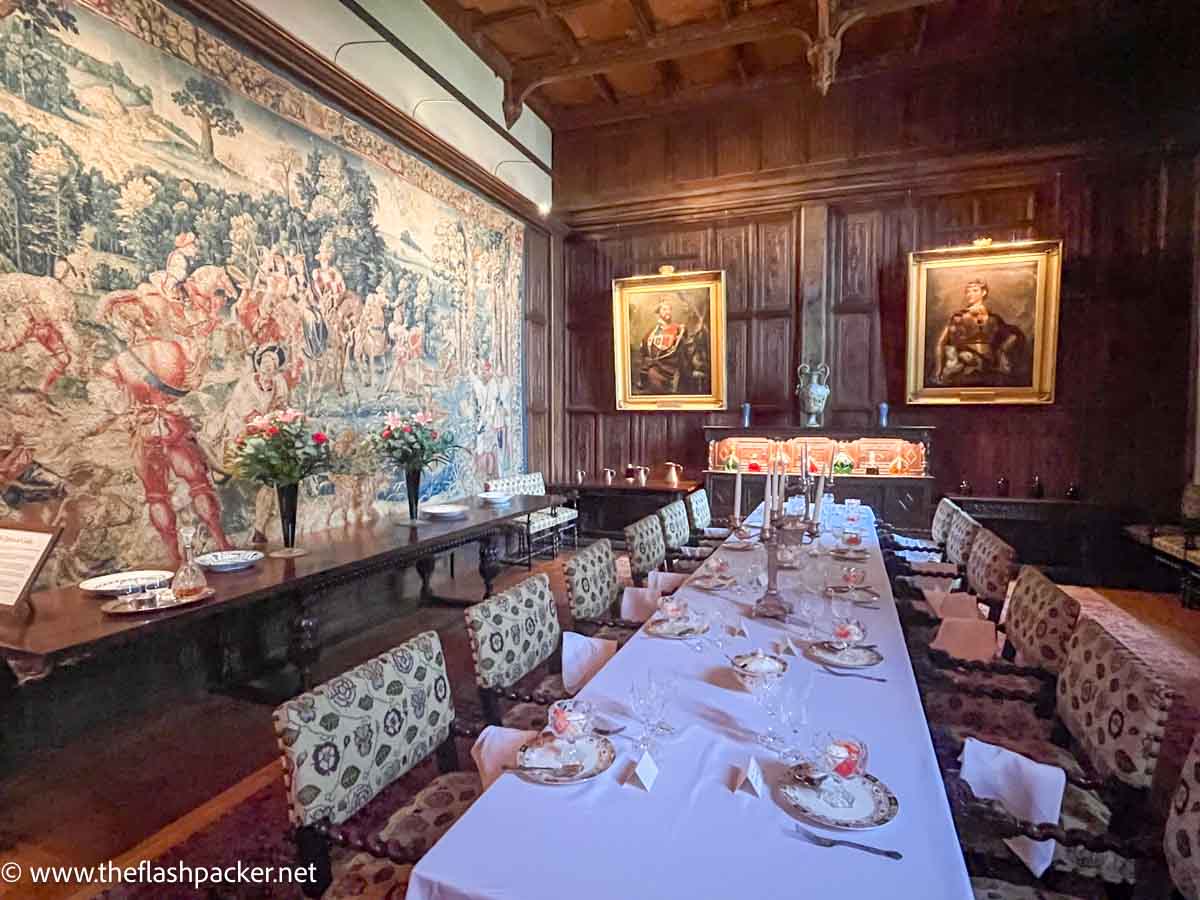 long table in dining room at hever castle with tapestry covering the length of one wall