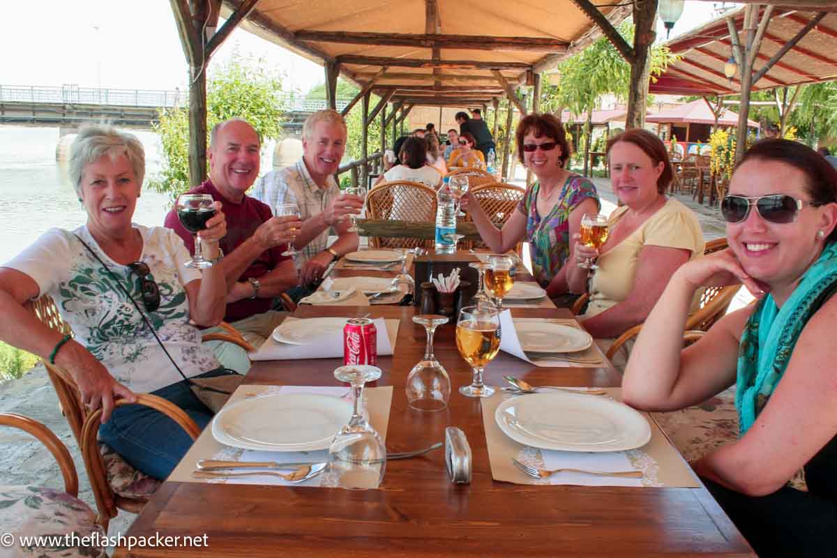 group of people sitting around a table in a restaurant