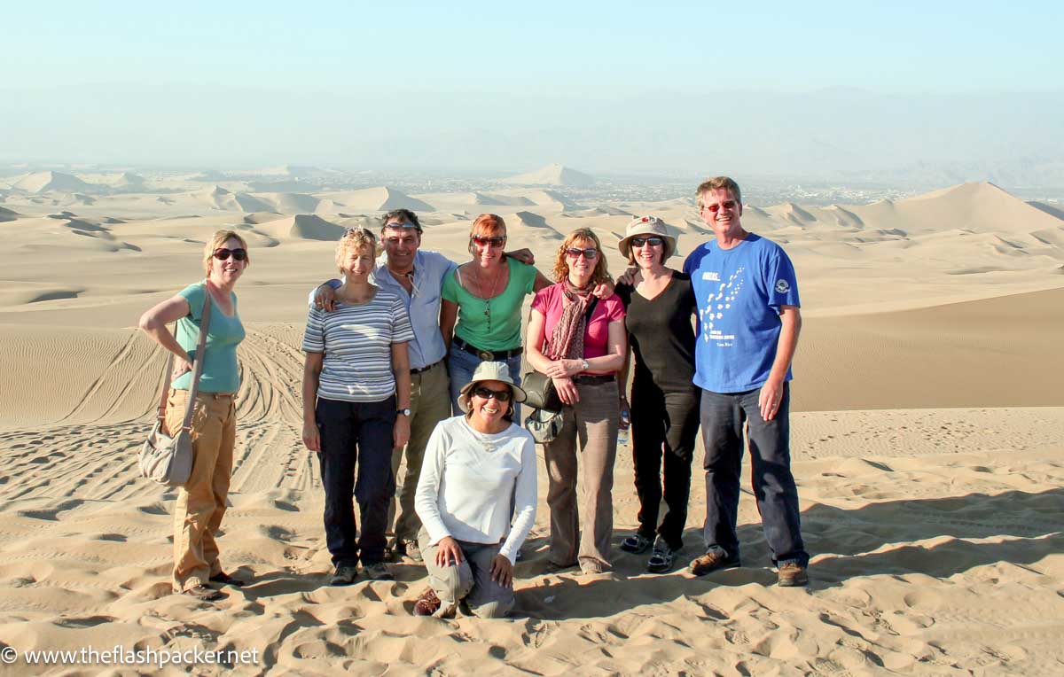 a group of travellers by a desert in peru