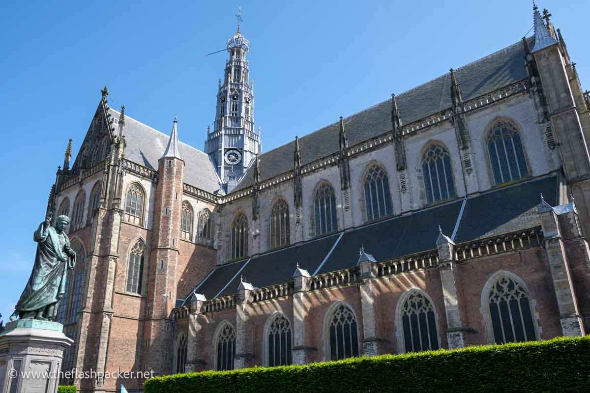 statue of a man outside st bavos church in haarlem