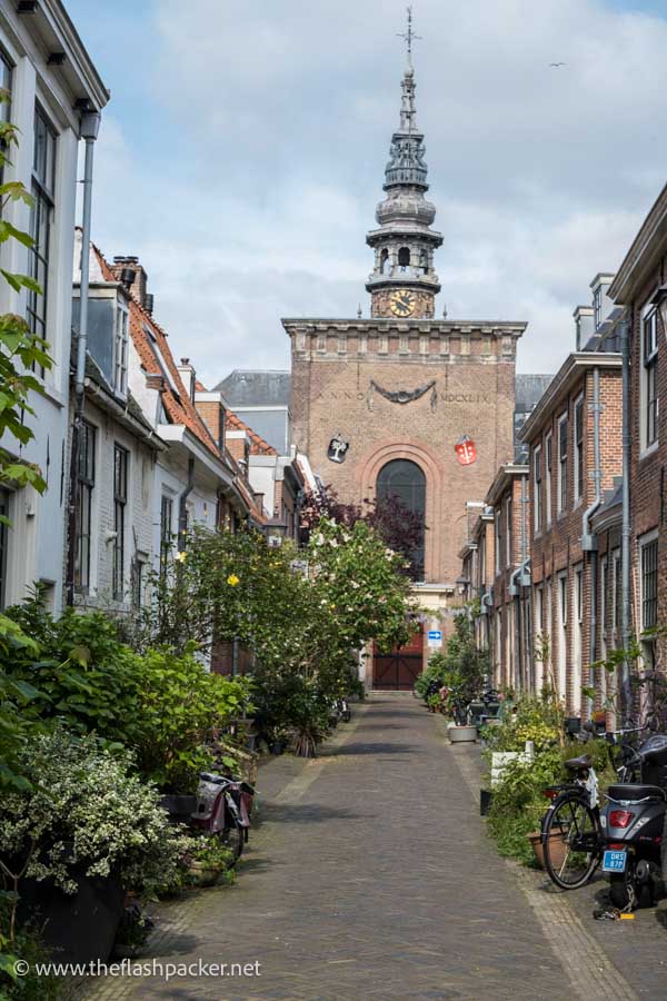 church with an ornate bell tower at the end of a pretty narrow street