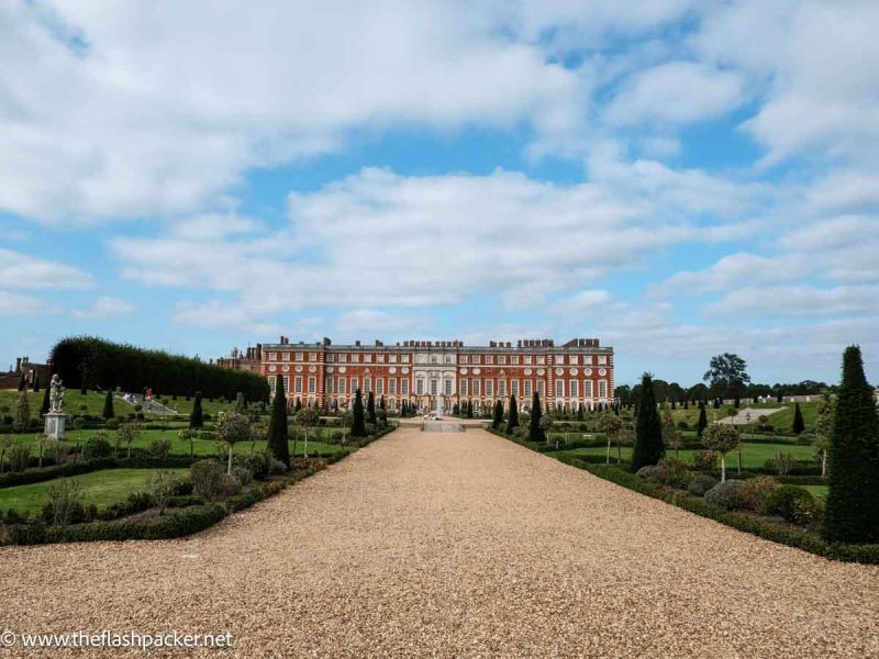 long avenue leading to red brick palace