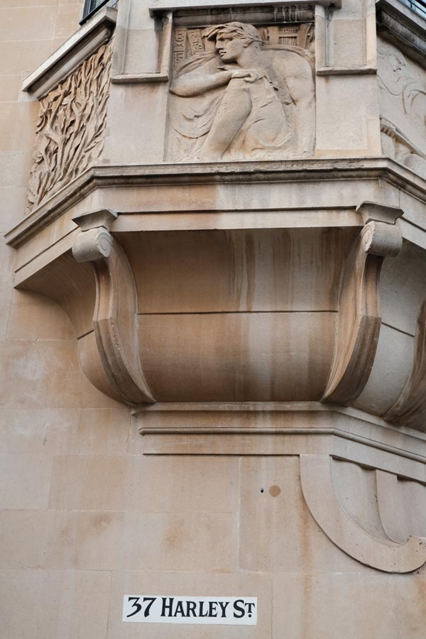 sign for 37 harley street under ornate stone balustrade