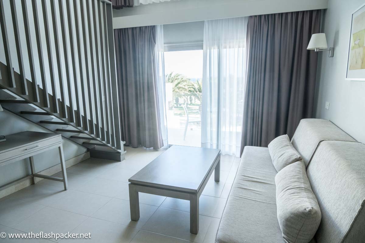 beige sofa and low table in room at hd beach hotel costa teguise lanzarote