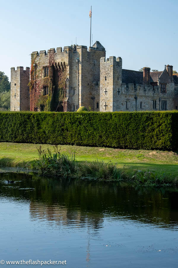 hever castle reflected in the water of the moat