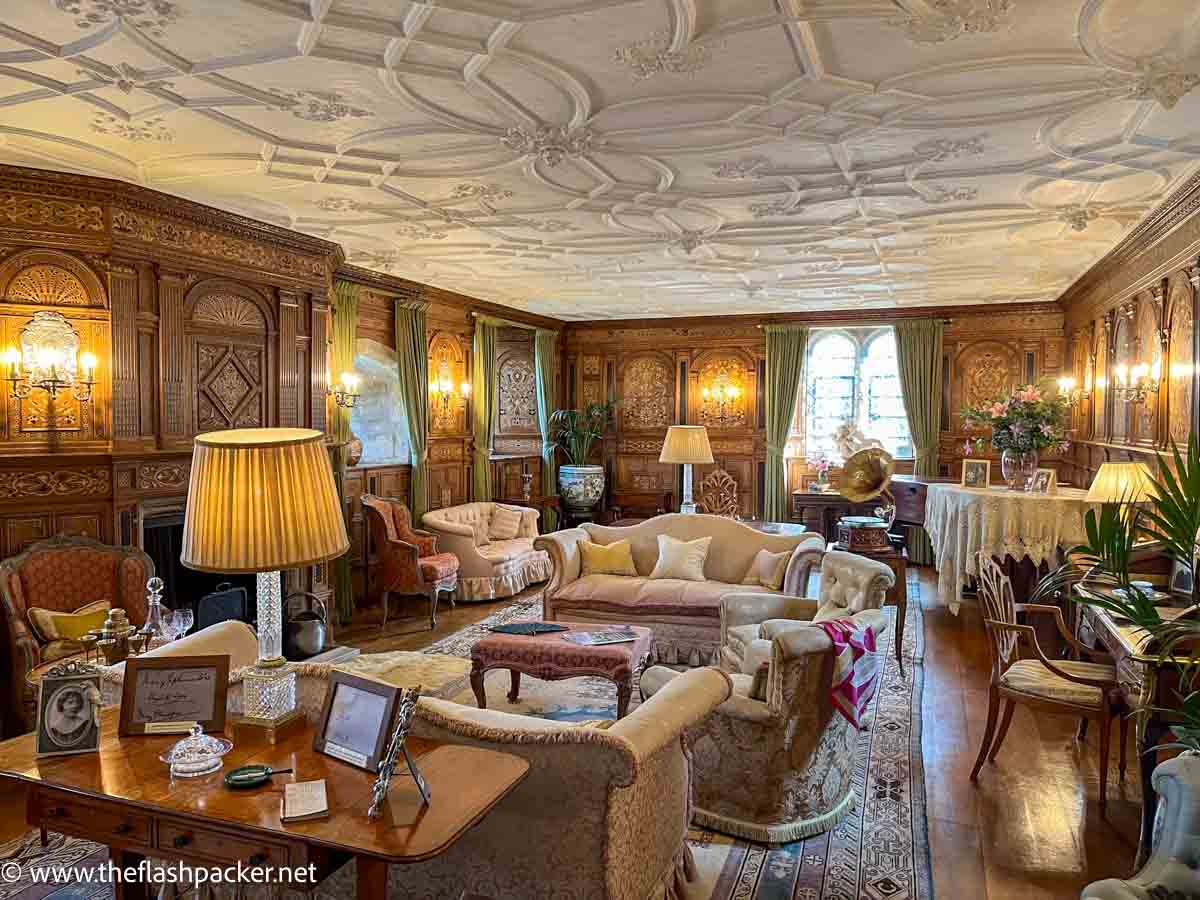 sumptuous drawing room at anne boleyn castle with inlaid wood panelling and plush sofas and chairs