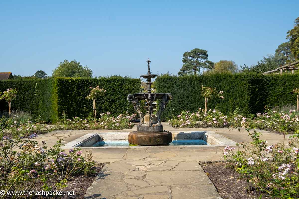 small fountain in the centre of a walled garden