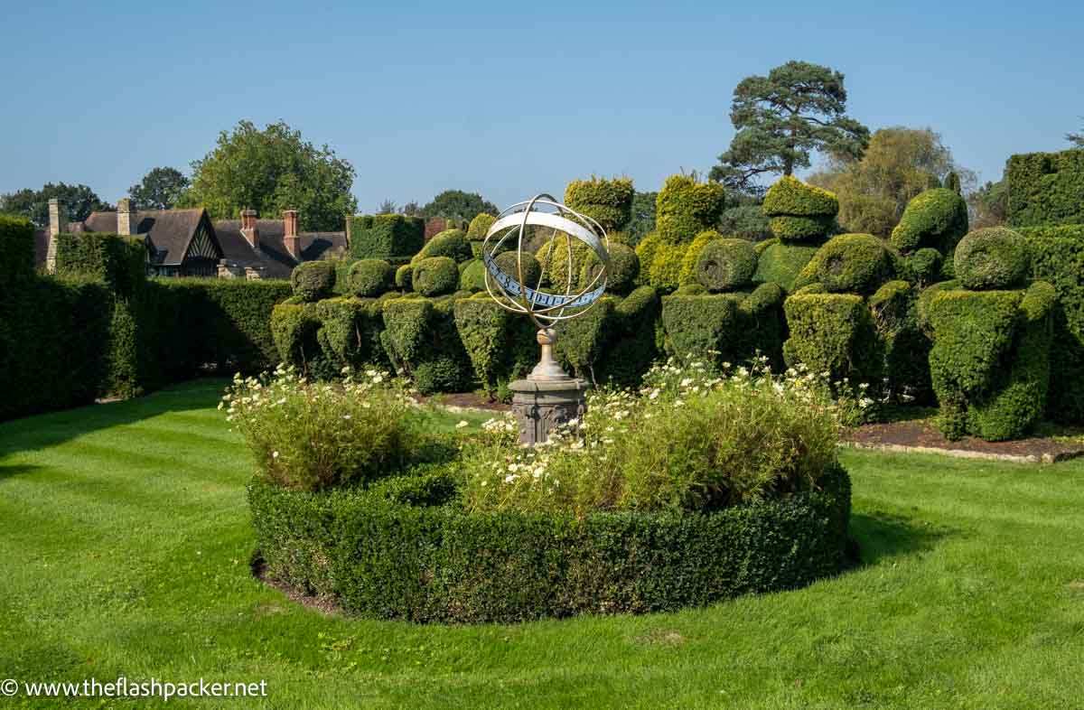 large topiary chess pieces in a manicured garden