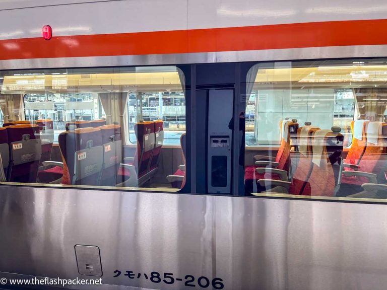 looking through the window into the empty carriage of the wide hida express train in japan