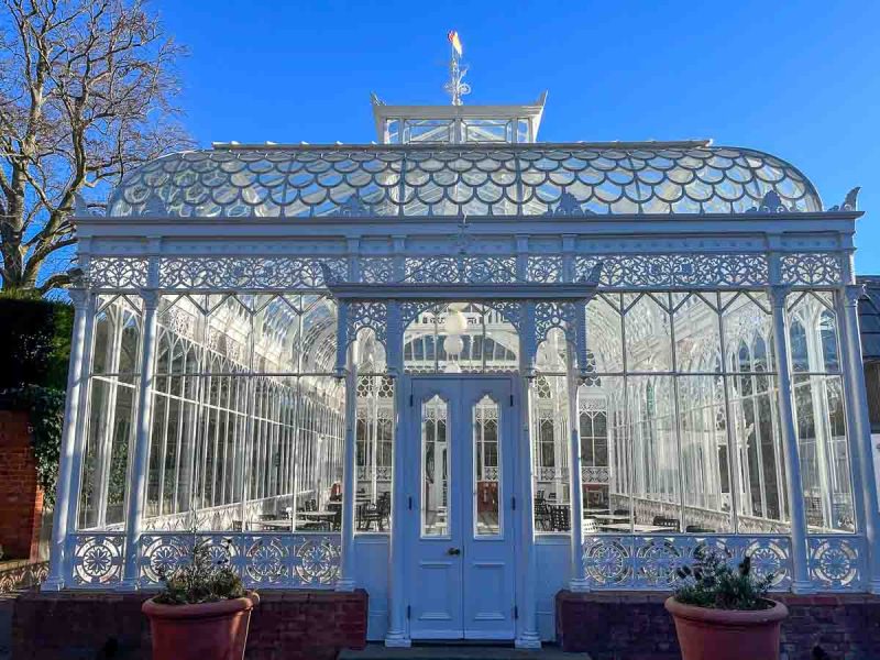 wrought iron white summer house under a blue sky