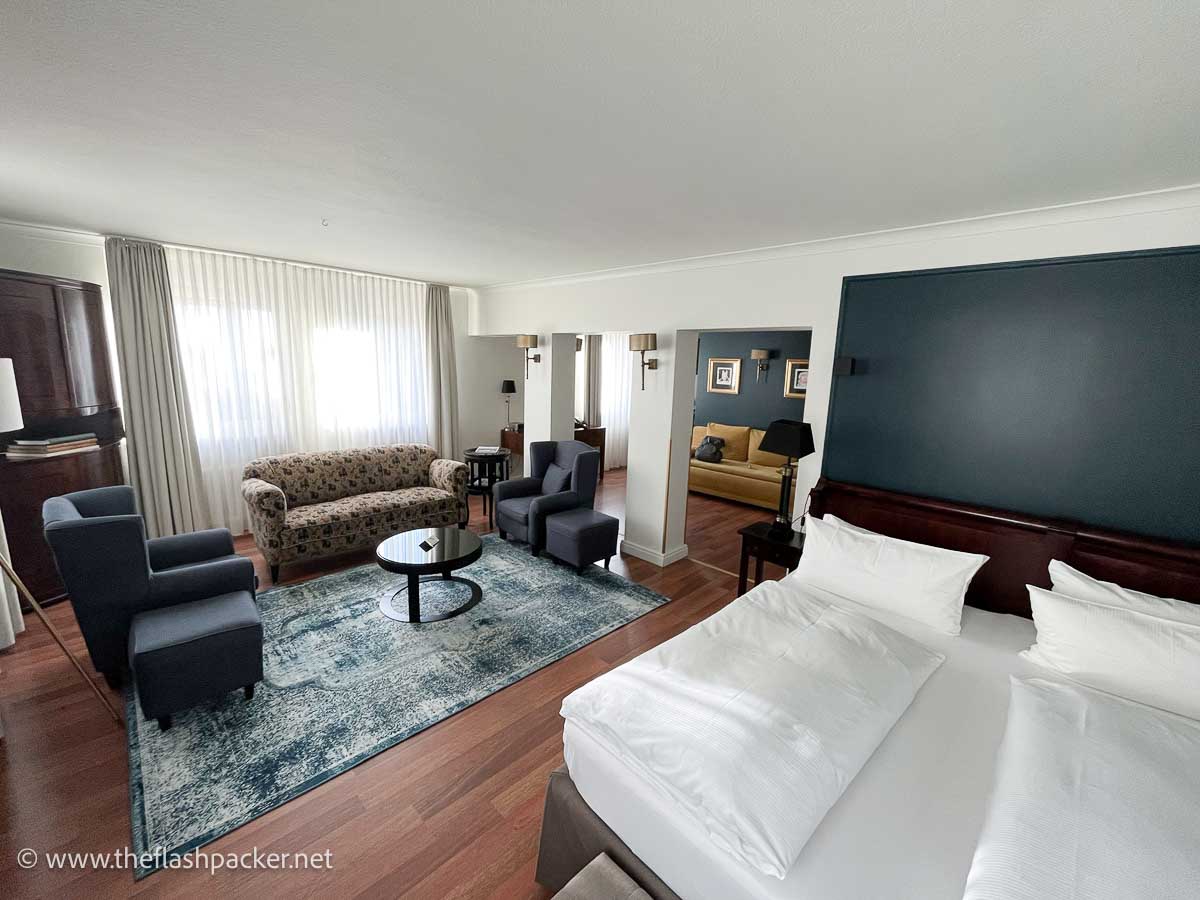 suite in hotel wurzburger hof with large bed and sofas and chairs