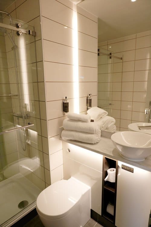 hotel bathroom with white toilet and sink unit