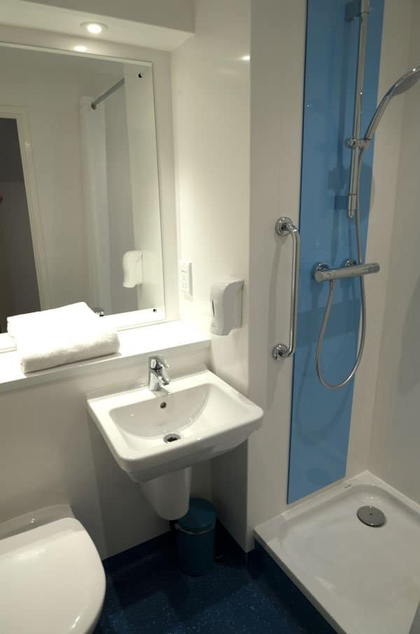 white bathroom with shower cubicle and sink