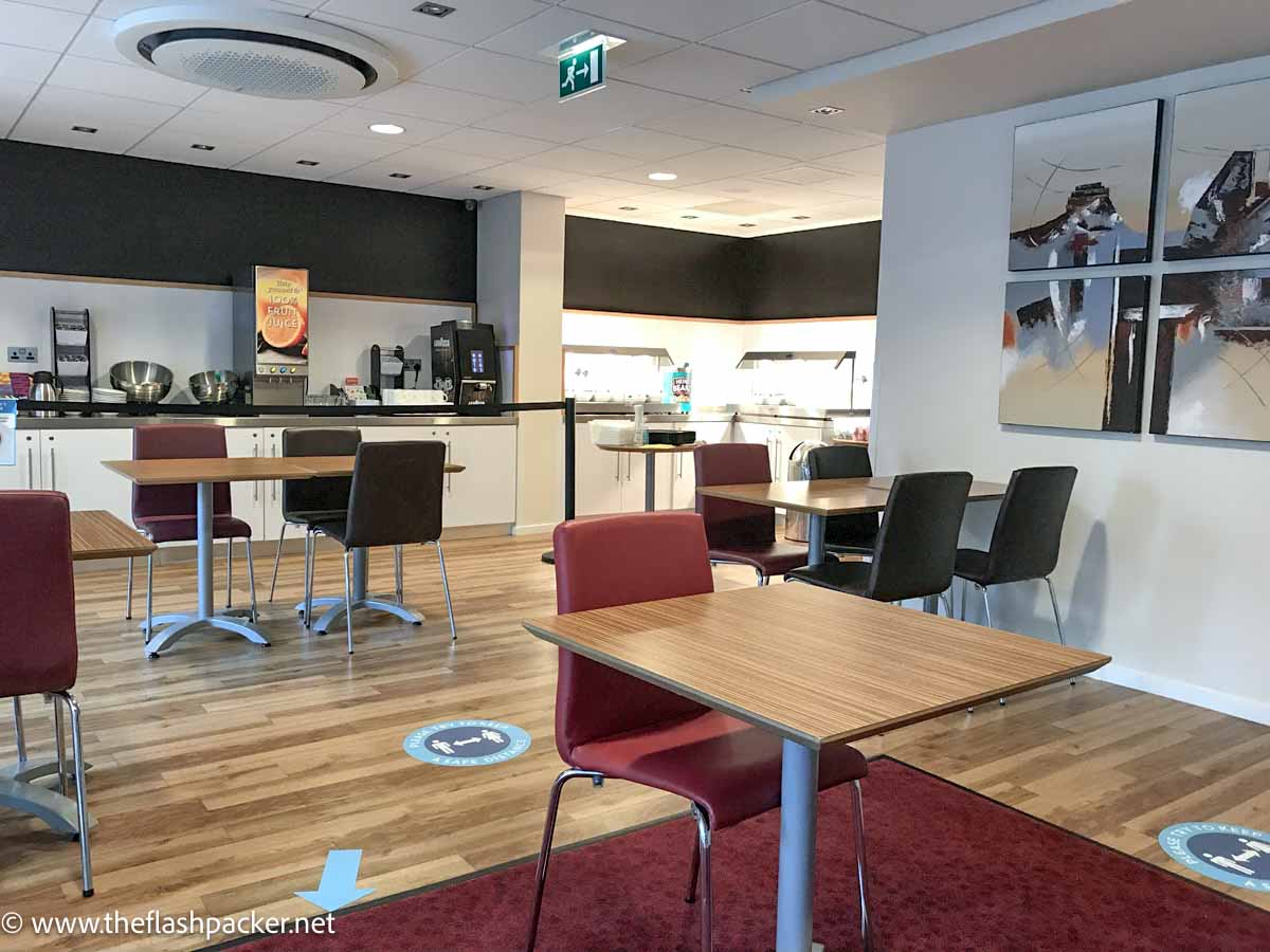 cafe area with wooden tables and red chairs