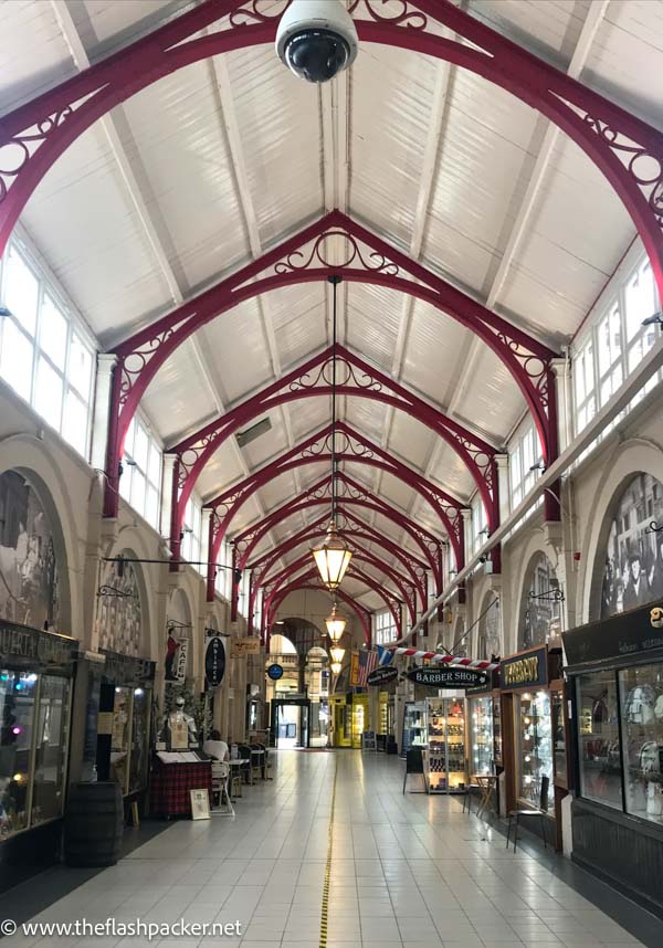 interior of arcaded victorian shopping arcade with red iron struts