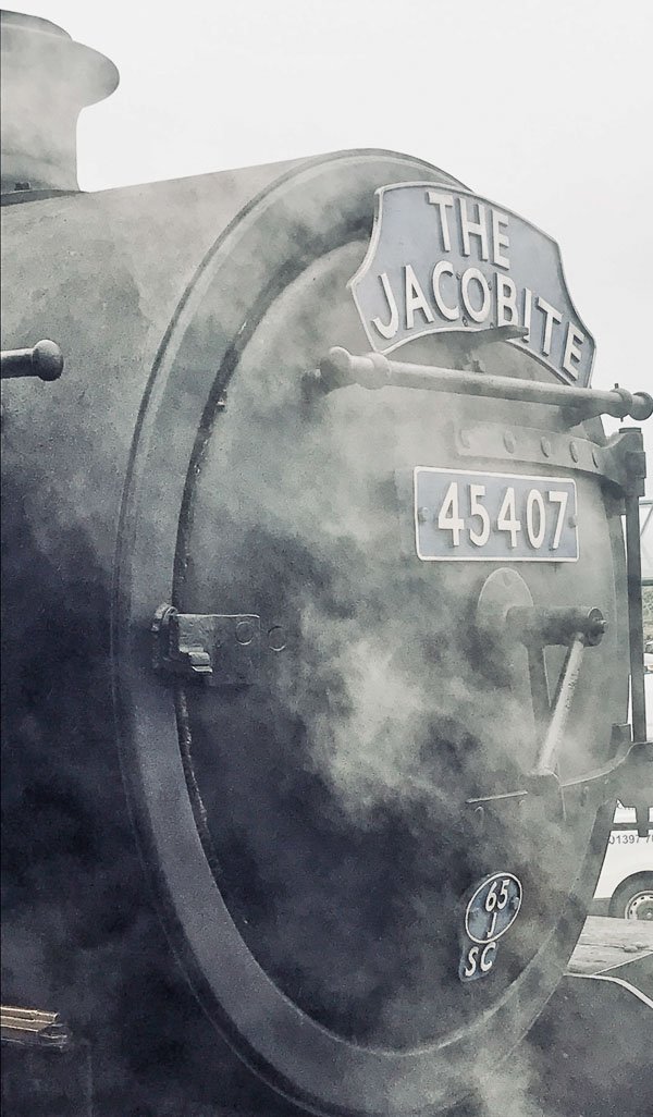 steam covering engine of jacobite train with livery and number