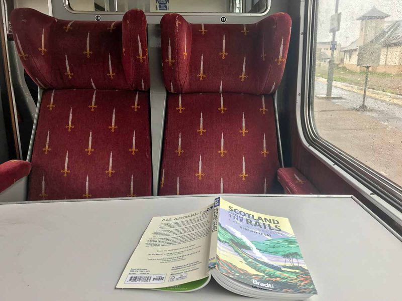 interior of vintage train carriage with book on table