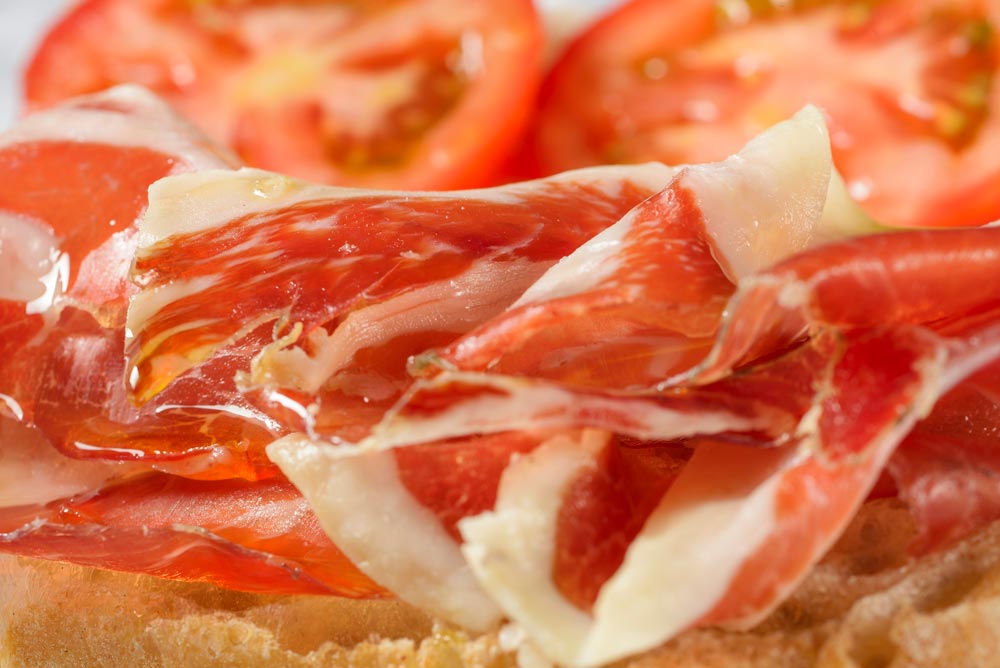 slices of spanish ham with tomatoes