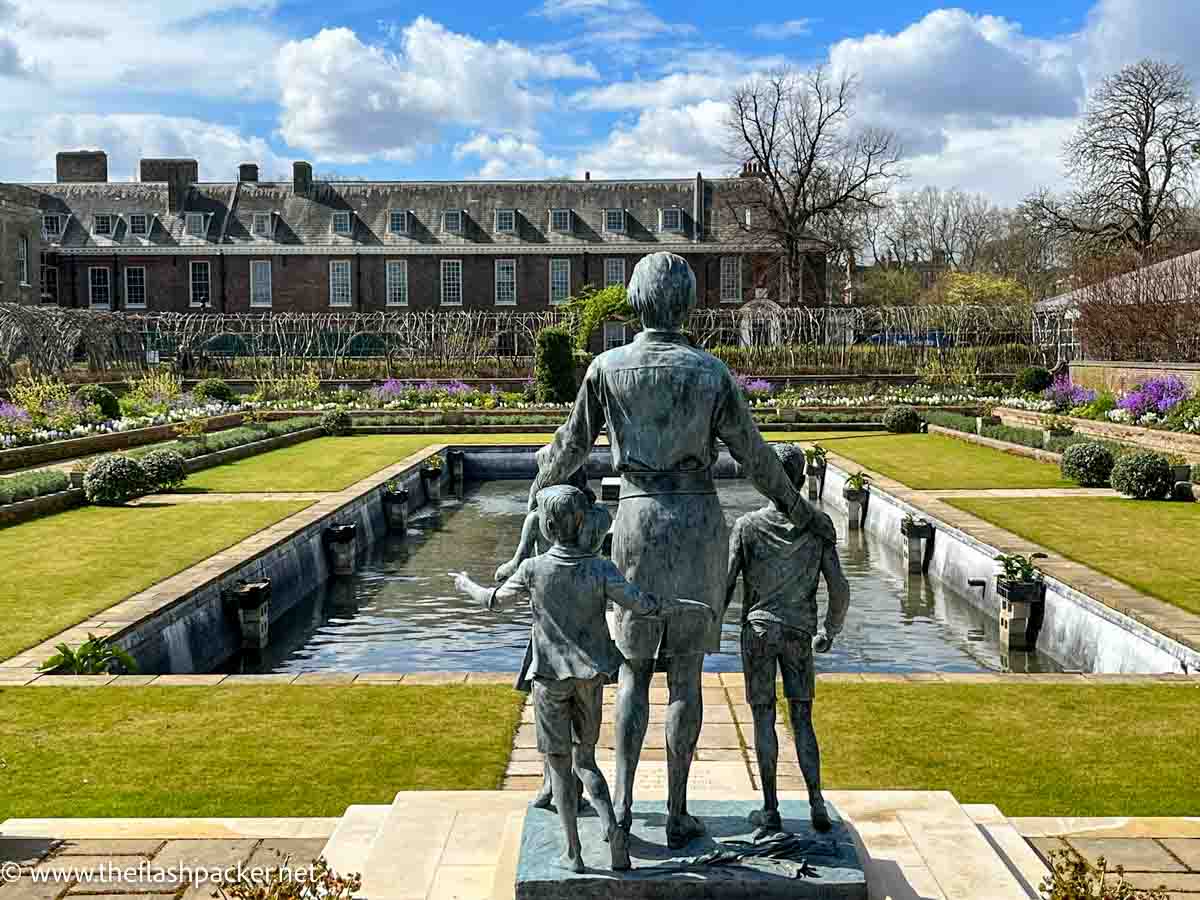 bronze diana statue of woman and children in front of fountain at kensington palace london