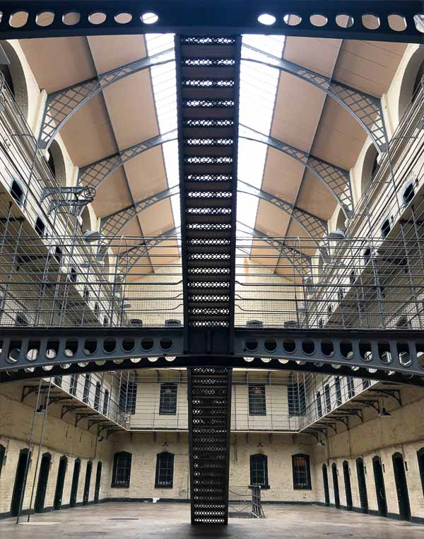 interior of kilmainham gaol with galleried cells and staircase