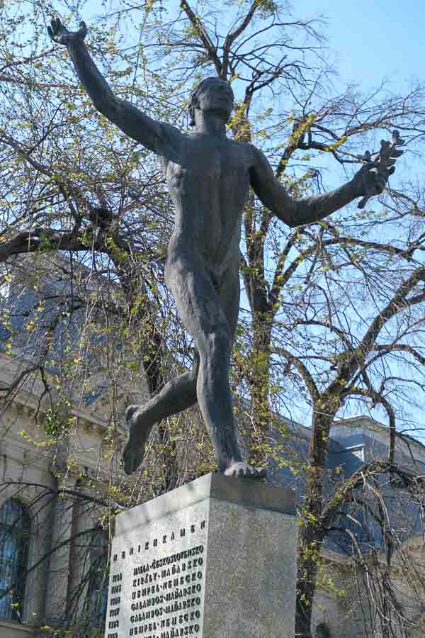 bronze statue of a marathon runner on a plinth