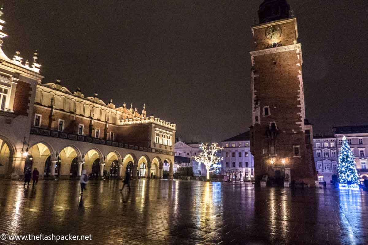 square in krakow at christmas eve lit up at night