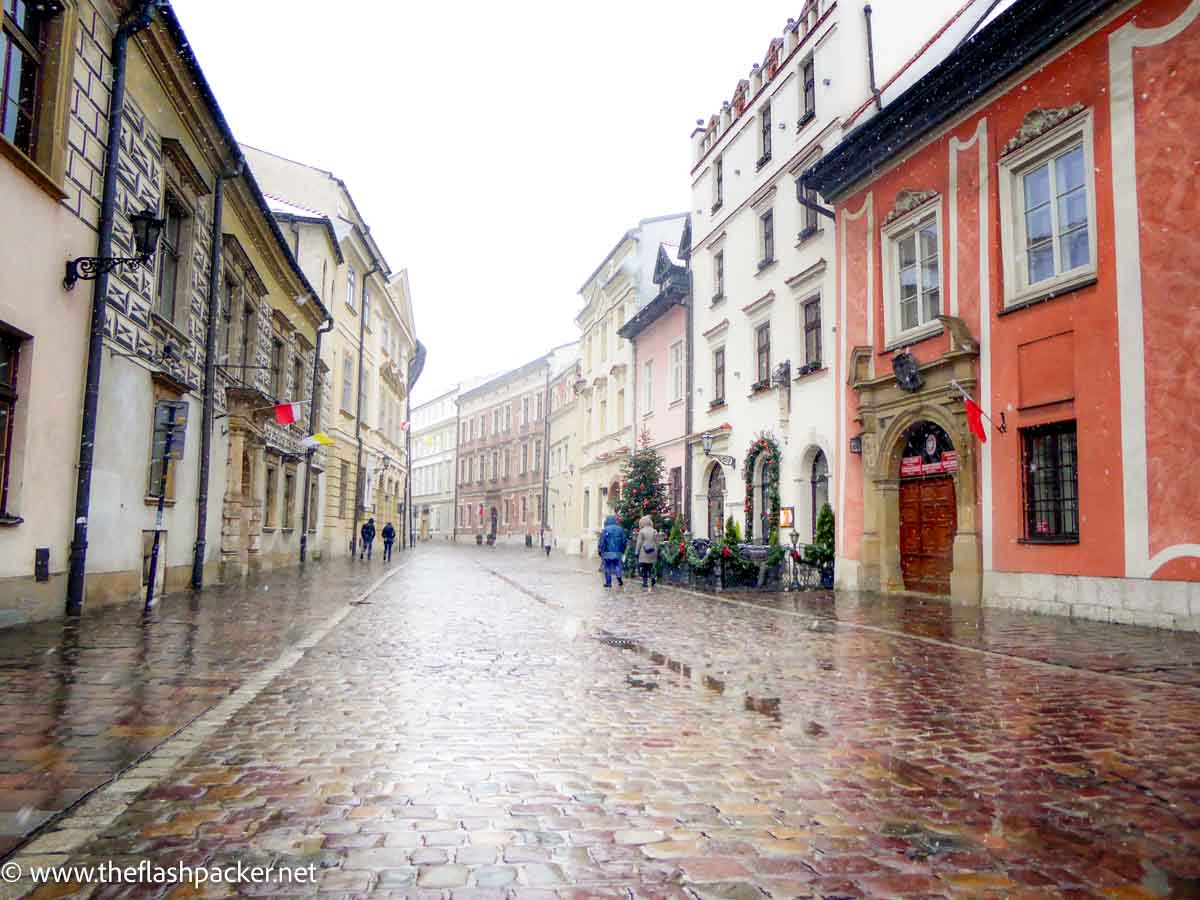 cobblestone street in rain in old street in krakow