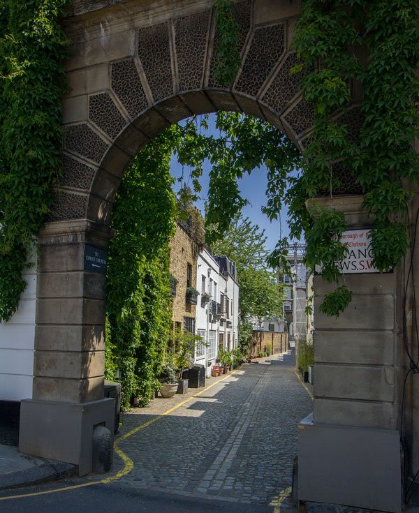 archway leading into a street of pretty mews houses