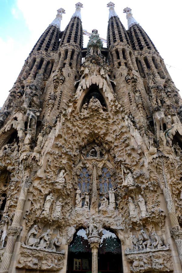 door of church with intricate carvings and 4 gothic spires