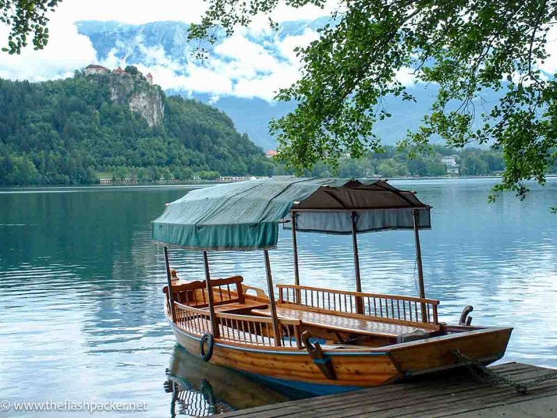 wooden boat by the side of lake bled