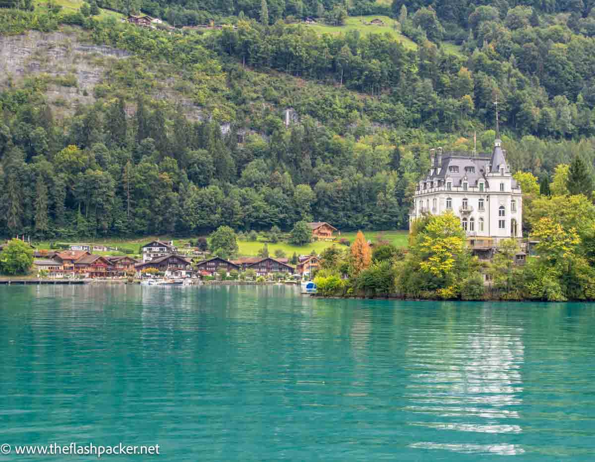 pea green water of lake brienz with buildings on shoreline