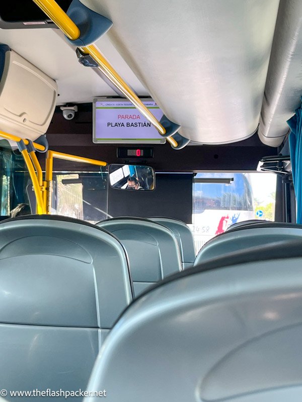 the interior of a modern bus with a sign showing the next stop