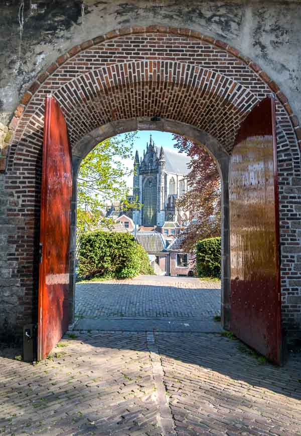 church seen through arched gateway in leiden