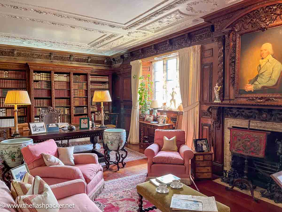 plush library at hever castle kent furnished with pink sofas and armchairs